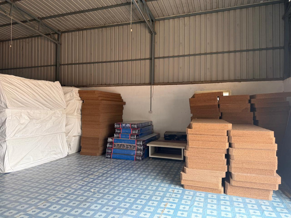 Rubberised coir sheets and finished mattresses in the material store
