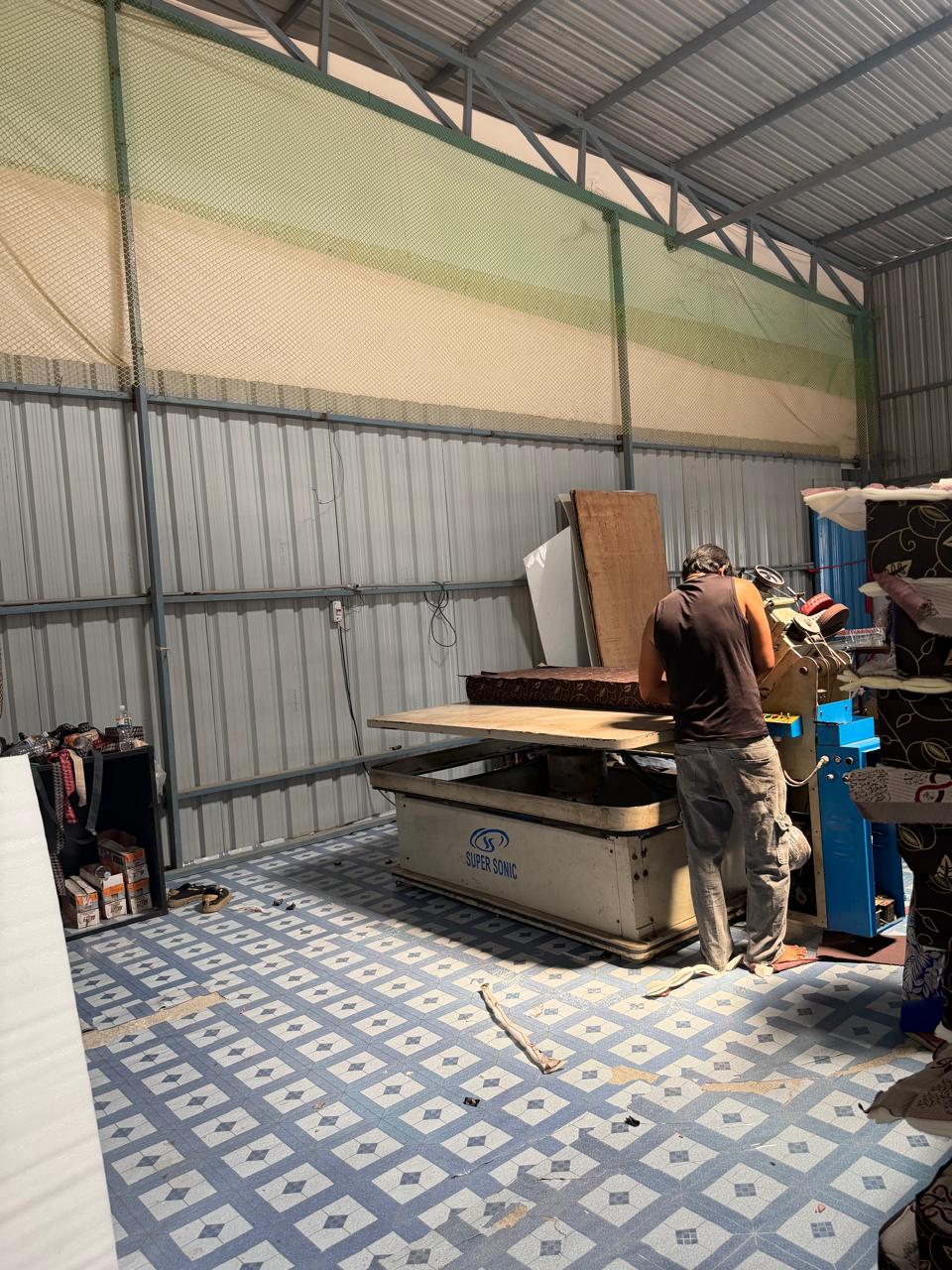 A mattress being finished on the tape-edge machine