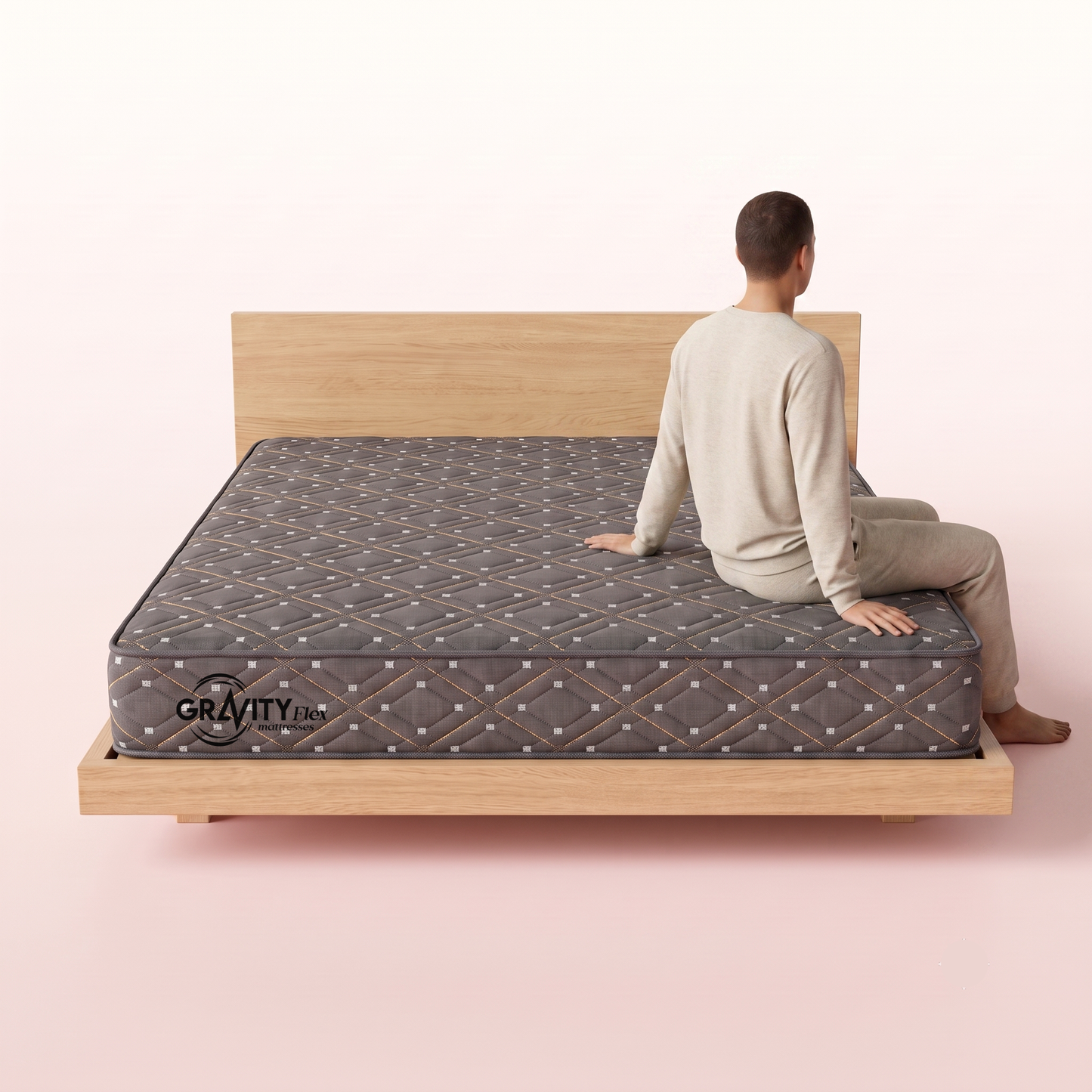 Person seated on the edge of a Gravity Flex Blanc 6 inch mattress